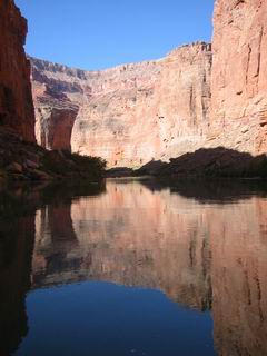 The water is so calm that you can see the canyon through its reflection.